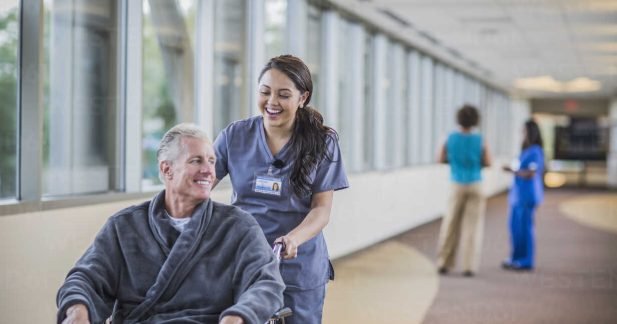 Nurse pushing patient in wheelchair